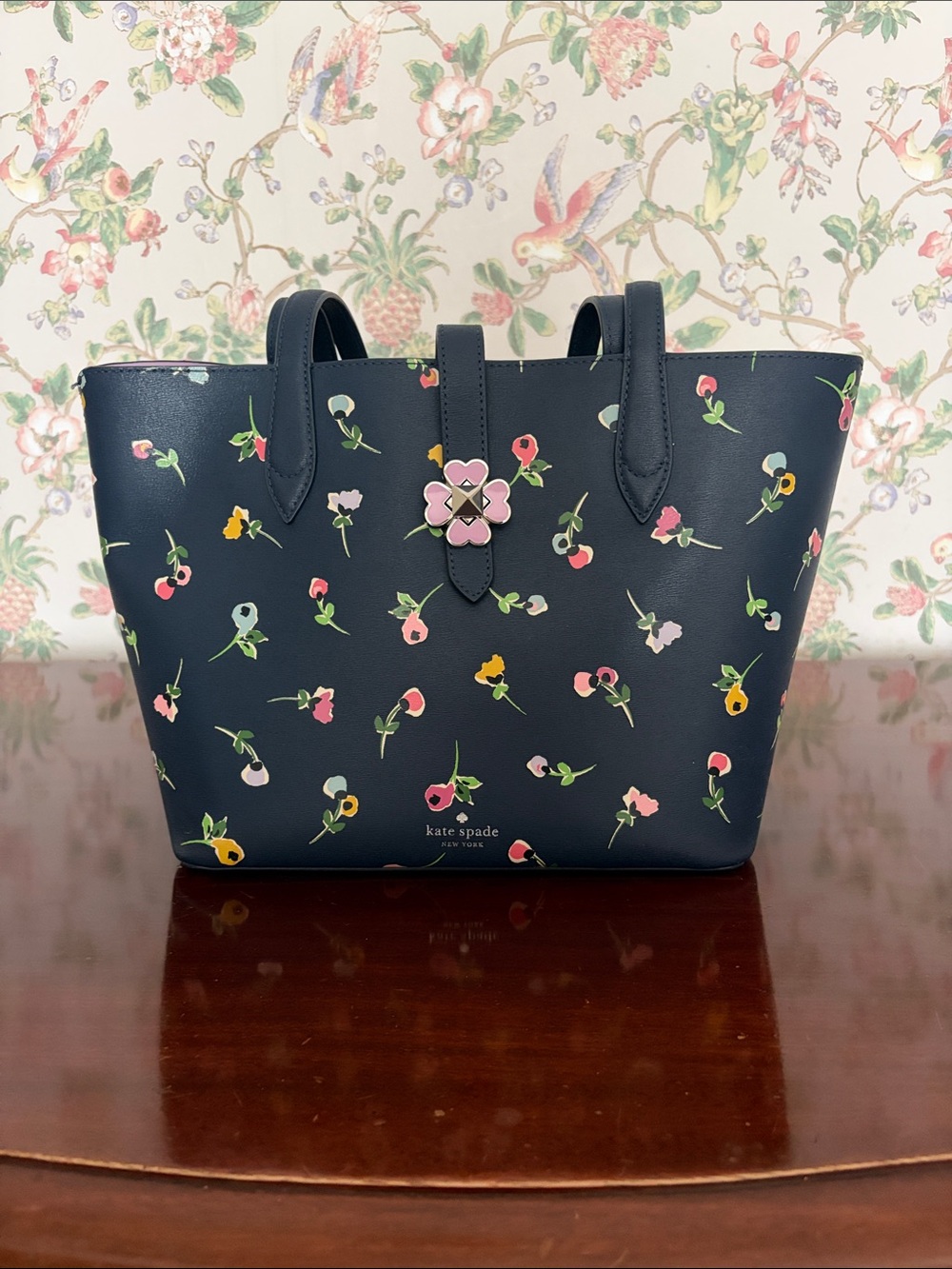 Kate Spade navy floral tote with pink flower clasp.